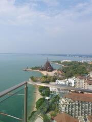 Scenic view from a balcony overlooking the ocean and buildings