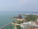 Scenic view from a balcony overlooking the ocean and buildings