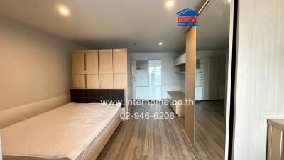 Bedroom with wooden flooring and furniture