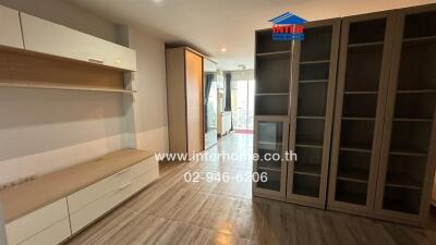 Spacious living room with built-in cabinets and sliding door wardrobe