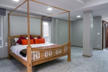 Spacious bedroom with a four-poster bed