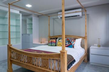 Cozy bedroom with wooden canopy bed and modern decor