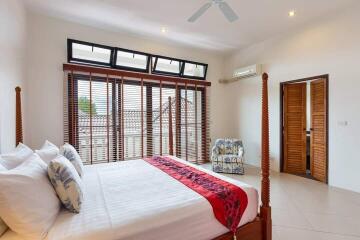 Spacious A/C bedroom with large windows and double bed