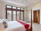 Spacious A/C bedroom with large windows and double bed