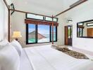 Bright spacious bedroom with a canopy bed and ocean view