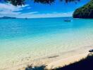 Scenic beach view with clear blue water and a boat in the distance