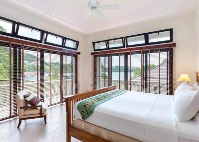 Spacious bedroom with large windows and a view