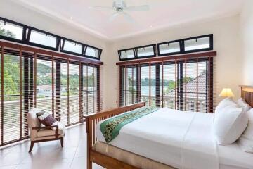 Spacious bedroom with large windows and a view