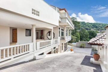 Exterior view of a multi-level house with balcony and staircase