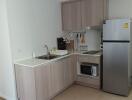 Modern kitchen with wooden cabinets, stainless steel sink, and appliances