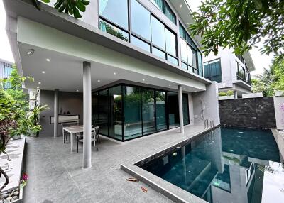 Modern residential patio with glass walls and pool