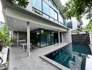 Modern residential patio with glass walls and pool