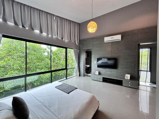 Modern bedroom with large windows and natural light