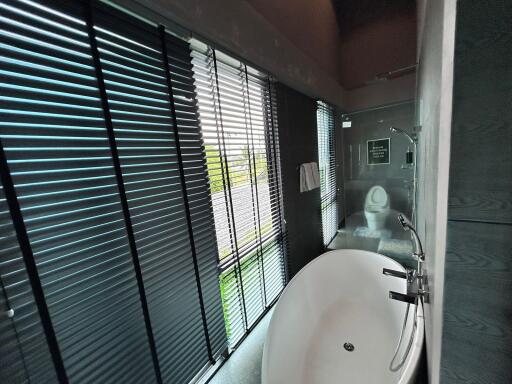 Modern bathroom with bathtub and large windows