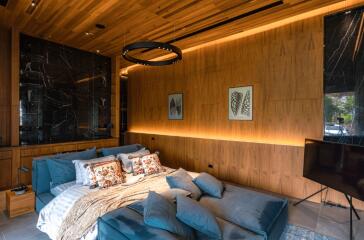 Luxurious modern bedroom with wooden wall panels and blue bedding