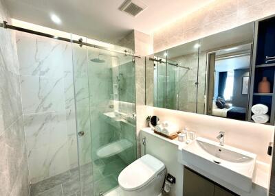Modern bathroom with glass shower and wall-mounted sink