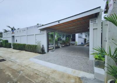 Photo of a modern residential building with a covered driveway