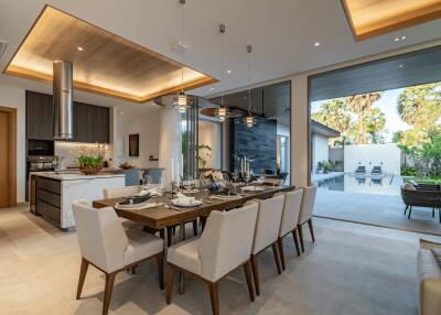 Modern dining room with large table and pool view