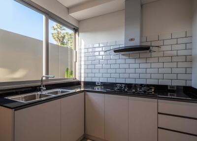 Modern kitchen with large window and subway tile backsplash