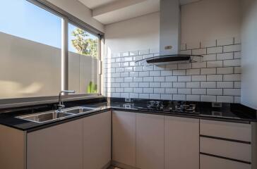 Modern kitchen with large window and subway tile backsplash