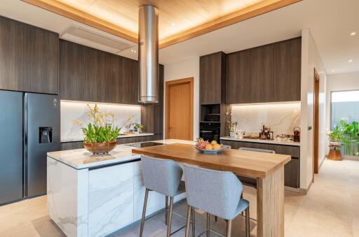 Modern kitchen with island, bar stools, and stainless steel appliances