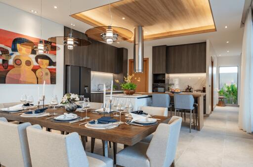 Modern dining room with a decorated table, adjacent to a contemporary kitchen