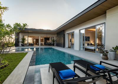 Modern outdoor area with a swimming pool and lounge chairs