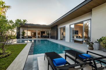 Modern outdoor area with a swimming pool and lounge chairs