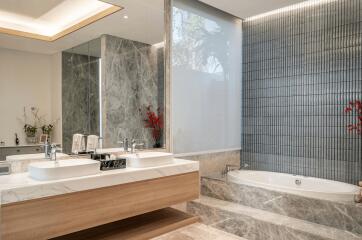 Modern bathroom with double sink, large mirrors, and bathtub