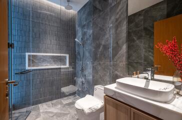 Modern bathroom with glass shower enclosure and large vanity