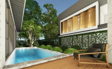Modern outdoor pool area with wooden deck and lounge chair