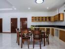 Spacious kitchen with wooden cabinets and dining table