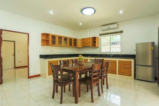 Spacious kitchen with dining area and wooden cabinetry