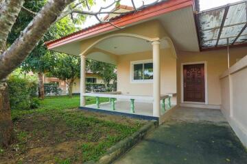 Front view of a house with a porch and garden