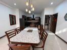 Dining area with a table set and view of the kitchen