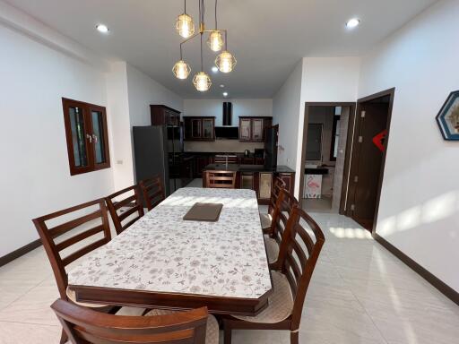 Dining area with a table set and view of the kitchen