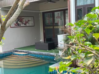 Patio area with outdoor seating and view of pool