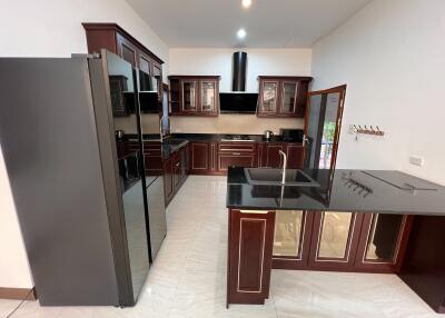 Modern kitchen with dark cabinetry and sleek appliances