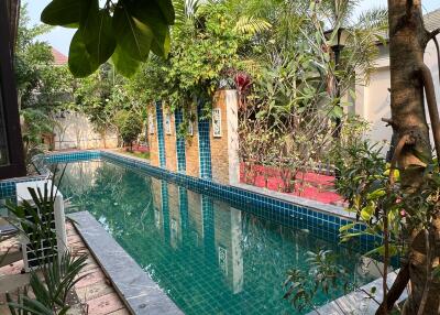 Private outdoor pool area with lush greenery