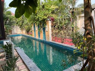 Private outdoor pool area with lush greenery