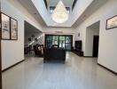 Spacious and well-lit living room with large chandelier