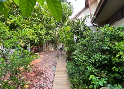 Beautiful garden area with lush greenery and a brick pathway