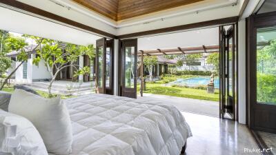 Spacious bedroom with open views to garden and pool area