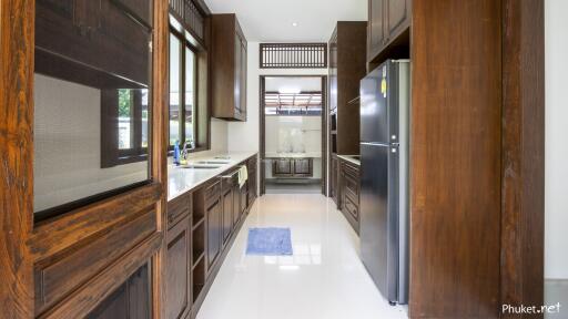 Modern kitchen with wooden cabinets and stainless steel appliances