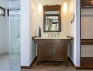 Modern bathroom with a wooden vanity, shower area, and dressing area