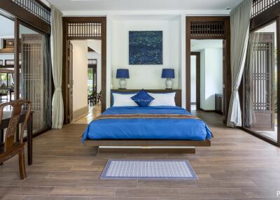 Spacious bedroom with blue bedding and modern decor