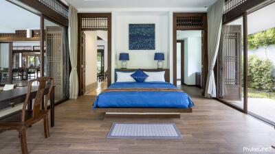 Spacious bedroom with blue bedding and modern decor