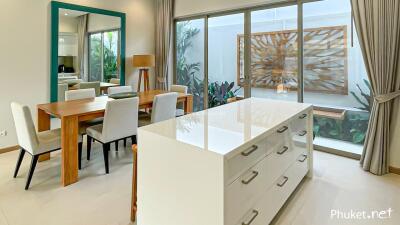 Modern kitchen and dining area with large island and contemporary decor