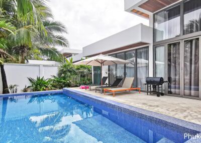 Modern house with swimming pool and lounge chairs