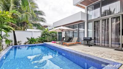 Modern house with swimming pool and lounge chairs